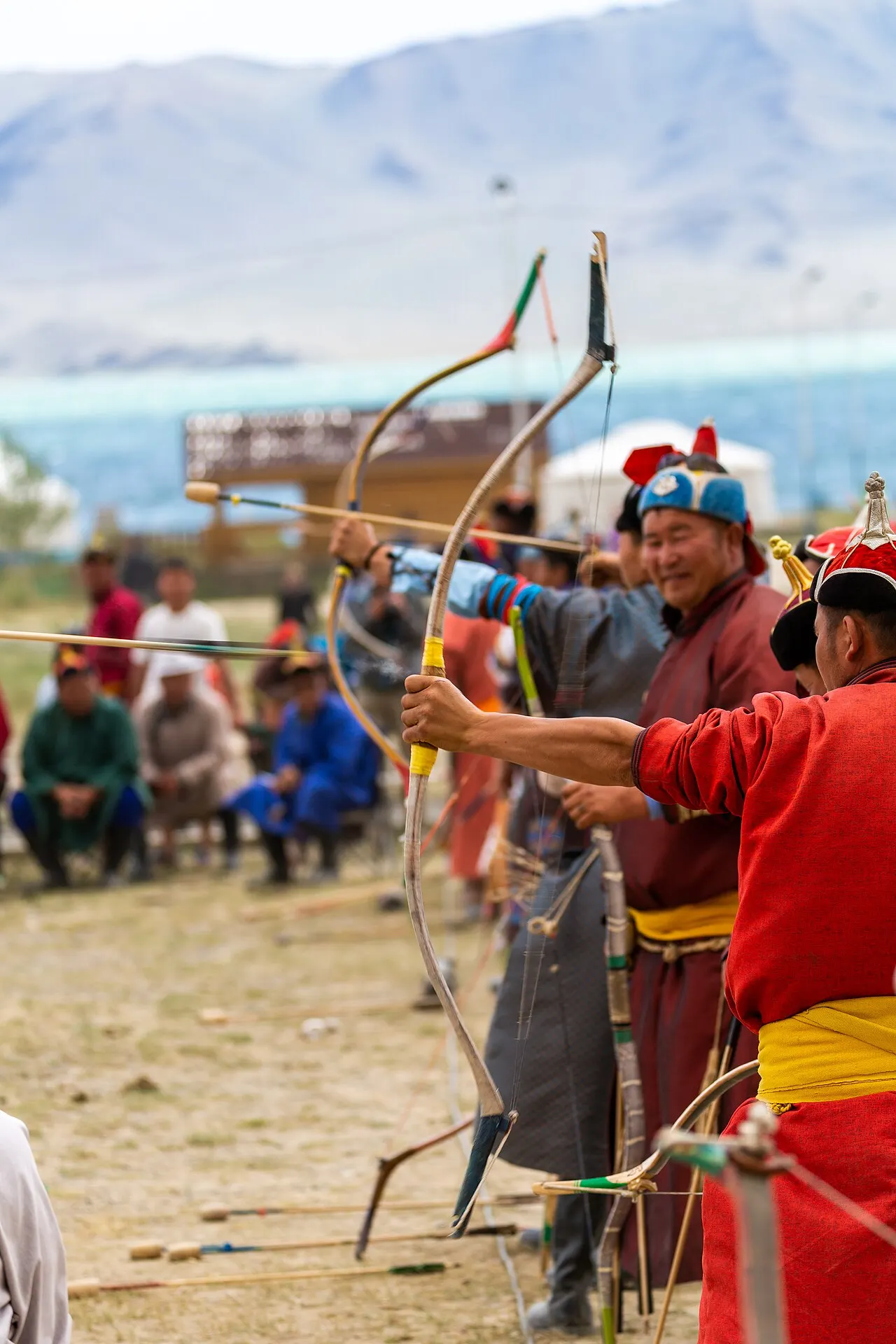 Mongolian archer at full draw in traditional dress
