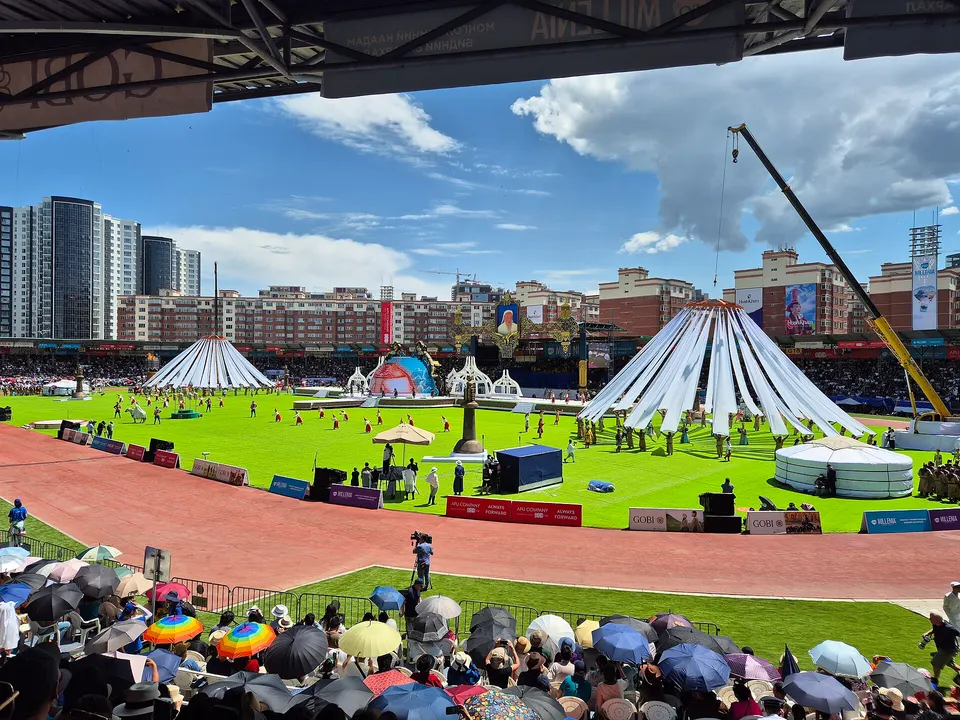 Naadam opening ceremony performance with raised white banners, Ulaanbaatar