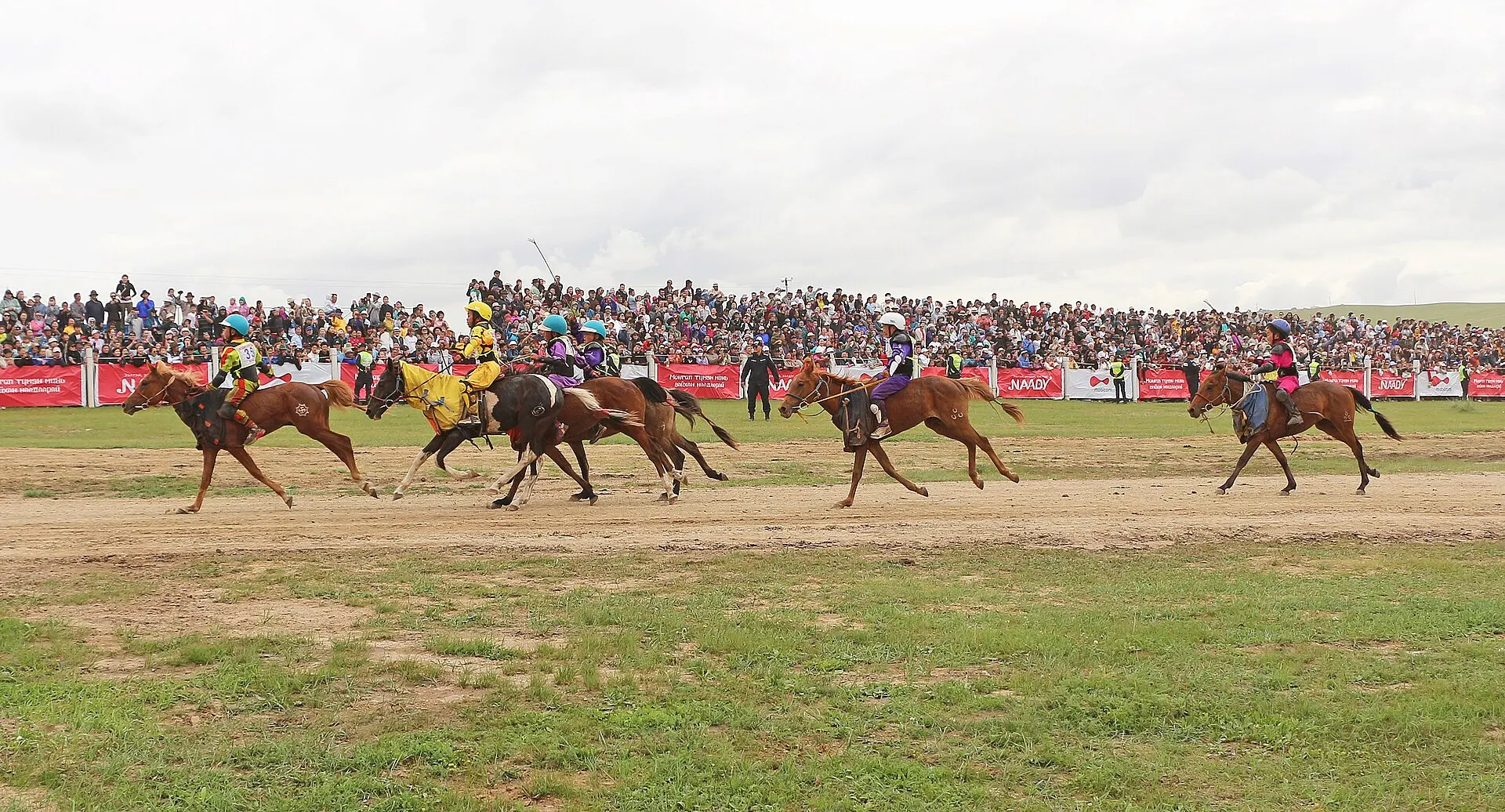 Young jockeys race toward the finish at Khui Doloon Khudag