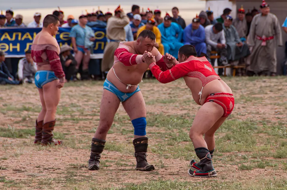 Mongolian wrestlers in zodog and shuudag grappling at Naadam