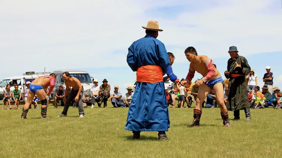 Wrestlers compete at a local countryside naadam